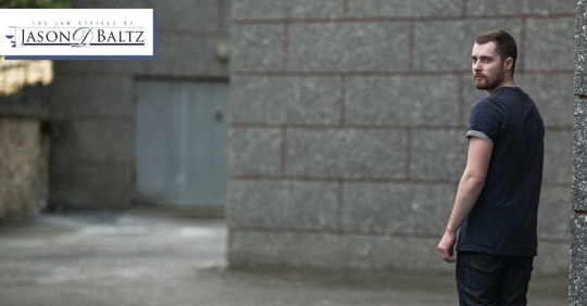 Man looking over his shoulder afraid that he is about to be arrested